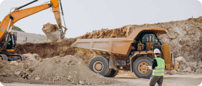 image shows a worker analyzing the work of construction equipment