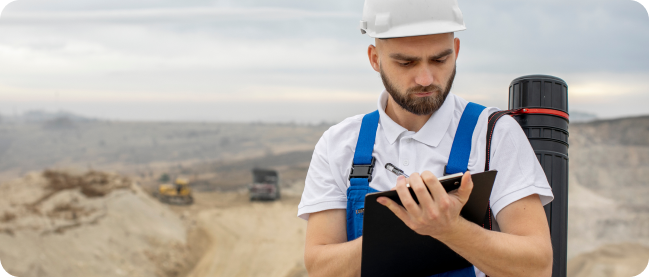 image shows a mine worker estimating the ground